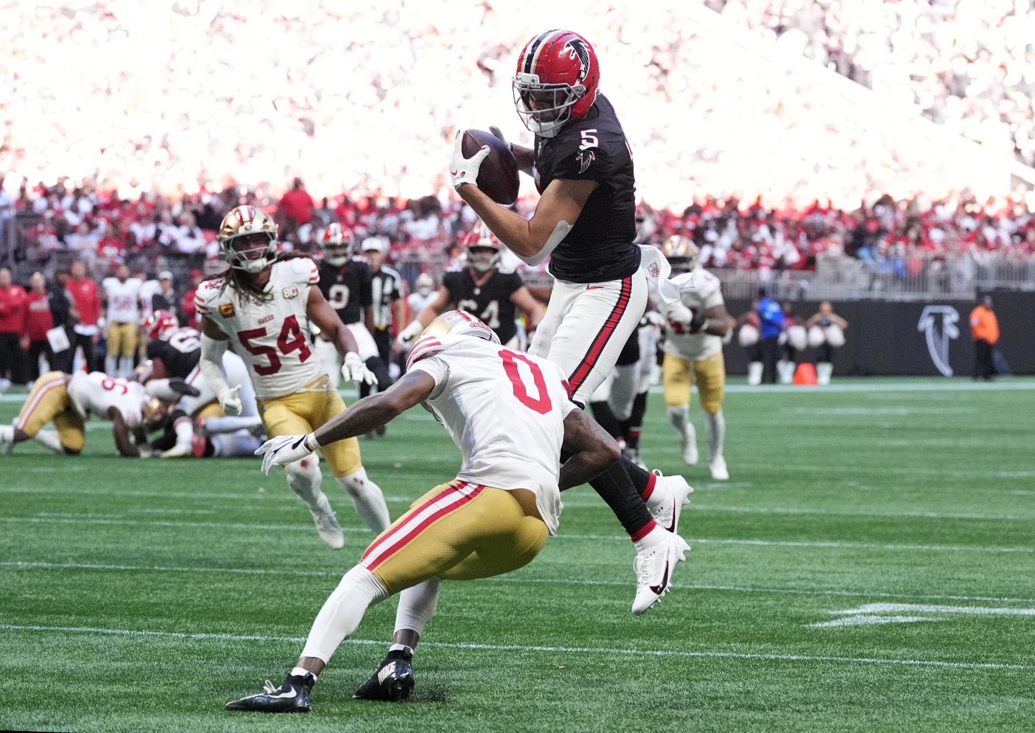 Atlanta Falcons wide receiver Drake London dives into the end zone for a touchdown past San Francisco 49ers cornerback Renardo Green.