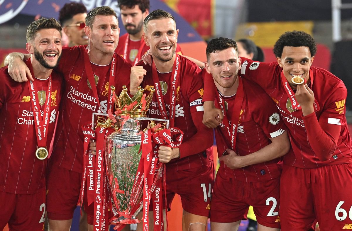 Jordan Henderson poses with the Premier League trophy