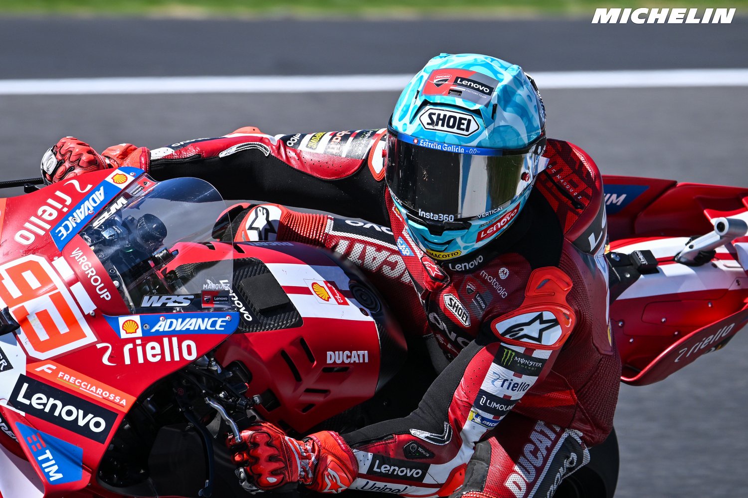 Rider in red Ducati leathers and Shoei helmet on a red Ducati MotoGP bike at the Australian GP practice, Ducati livery visible