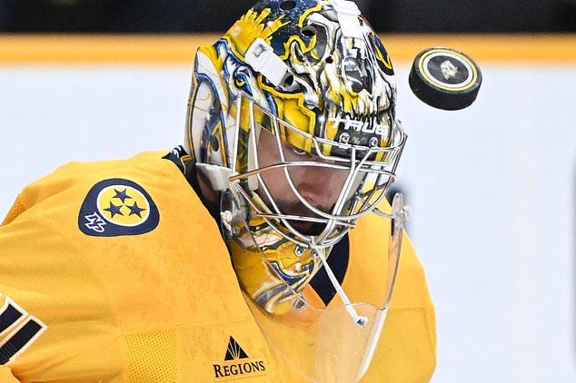 Nashville Predators goaltender Juuse Saros (74) makes a save against the New York Islanders during the first period of an NHL hockey game Tuesday, Oct. 27, 2026, in Nashville, Tenn. (AP Photo/John Amis)