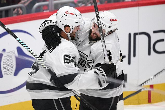 Los Angeles Kings defenseman Erik Gustafsson (64) celebrates his goal with defenseman Drew Doughty (8) during the third period of an NHL hockey game against the Washington Capitals, Tuesday, Oct. 20, 2026, in Washington. (AP Photo/Nick Wass)