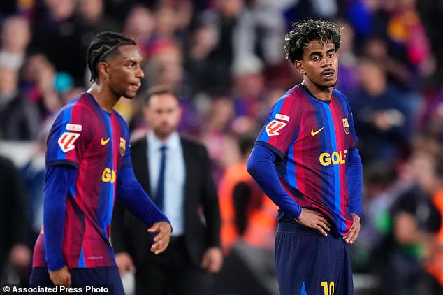 Barcelona's Lamine Yamal, right, and Barcelona's Alejandro Balde react at the end of the Spanish La Liga soccer match between FC Barcelona and Real Madrid in Barcelona, Spain, Sunday, Oct. 25, 2026. (AP Photo/Jose Breton)