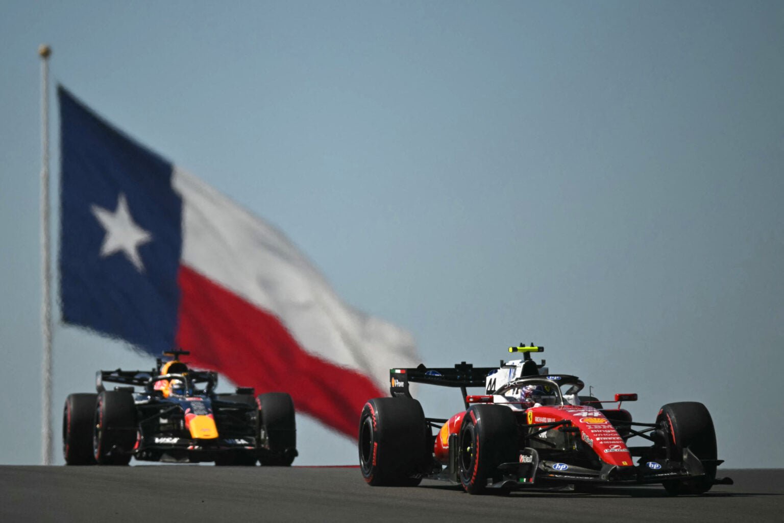 Ferrari driver Lewis Hamilton leads Red Bull's Max Verstappen on track during FP1 at the 2026 F1 United States Grand Prix