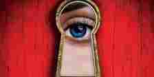 The cover of The Housemaid's Secret featuring a red background and an eye looking through a keyhole