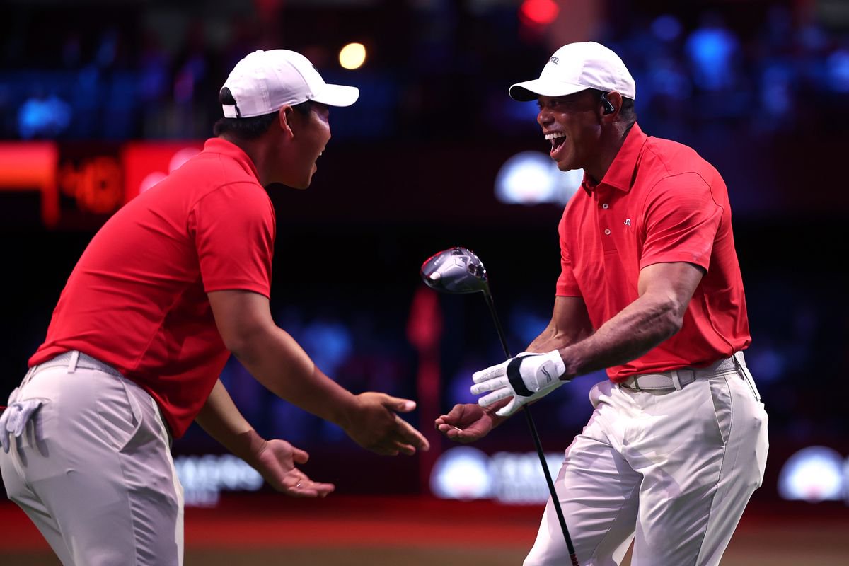 Tiger Woods celebrates with Tom Kim during a TGL match