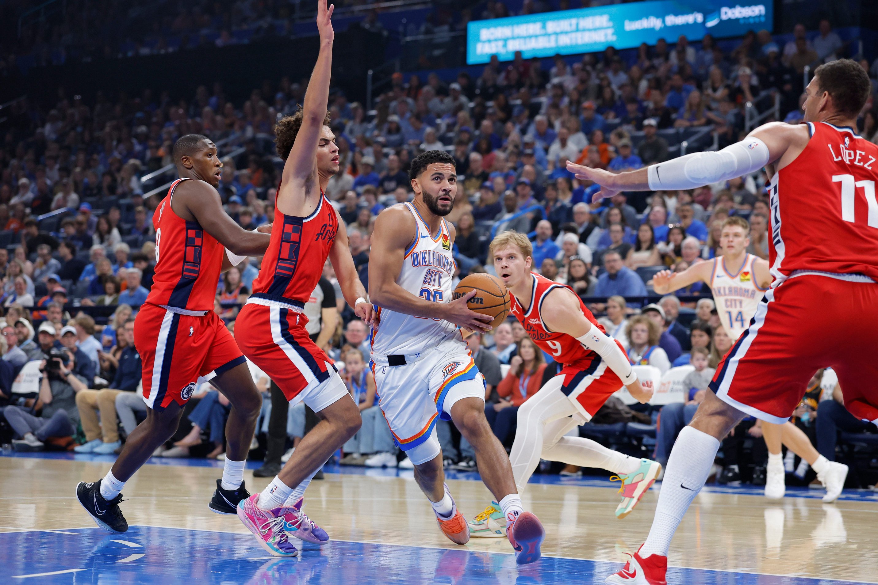 Oct 25, 2026; Oklahoma City, Oklahoma, USA; Oklahoma City Thunder guard Ajay Mitchell (25) drives to the basket against the Los Angeles Clippers during the first half at Paycom Center. Mandatory Credit: Alonzo Adams-Imagn Images