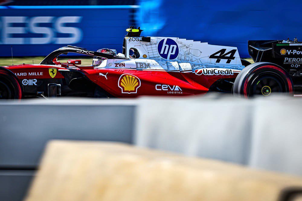 Ferrari F1 car number 44 on track at Austin practice, with HP, Shell and UniCredit livery; driver shown from behind the wall.