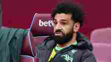 Mohamed Salah makes a funny face while sat on the bench