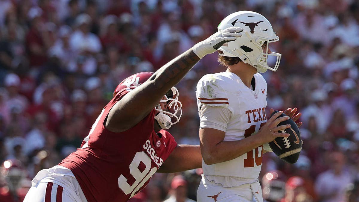 Arch Manning is tackled by Trent Wilson during the first half at Cotton Bowl.