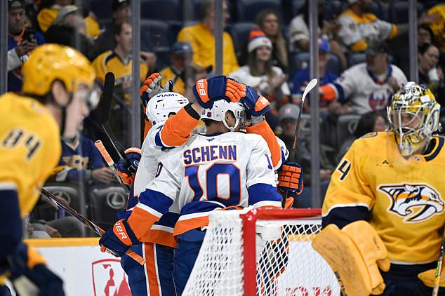 New York Islanders center Brayden Schenn (10) is congratulated after scoring a goal against the Nashville Predators during the first period of an NHL hockey game Tuesday, Oct. 27, 2026, in Nashville, Tenn. (AP Photo/John Amis)