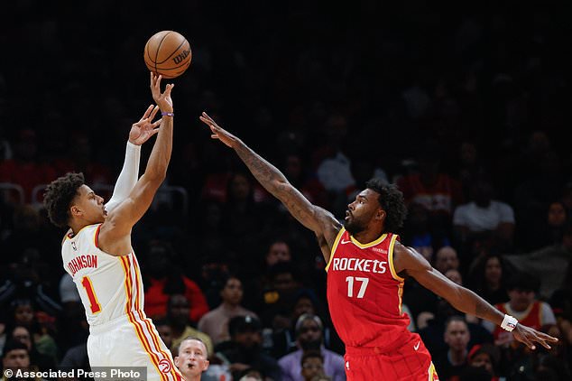 Atlanta Hawks forward Jalen Johnson (1) shoots against Houston Rockets forward Tari Eason (17) during the first half of an NBA basketball game, Saturday, Oct. 24, 2026, in Atlanta. (AP Photo/Erik S. Lesser)