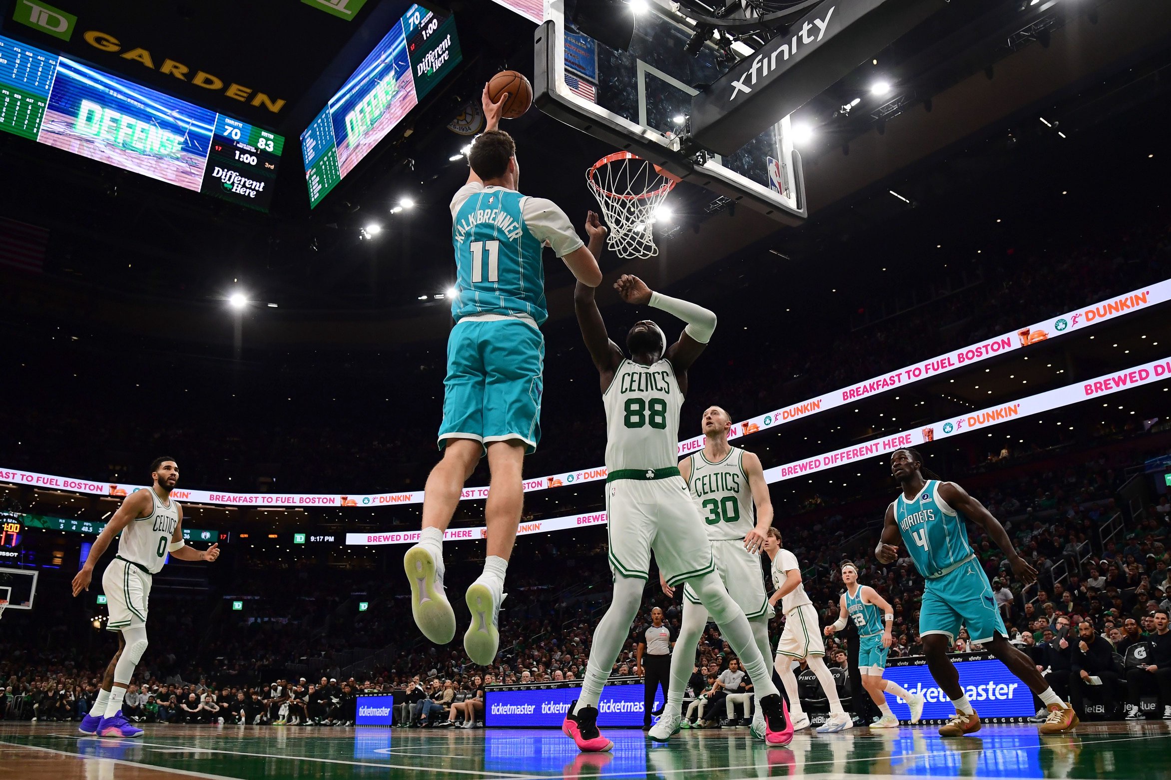 Oct 14, 2026; Boston, Massachusetts, USA;  Charlotte Hornets center Ryan Kalkbrenner (11) shoots the ball ver Boston Celtics center Neemias Queta (88) during the second half at TD Garden. Mandatory Credit: Bob DeChiara-Imagn Images