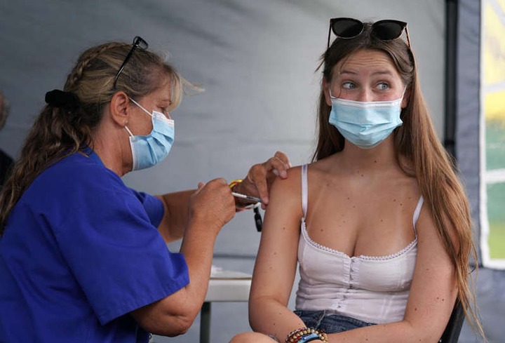 a woman wearing glasses: Covid-19 Vaccination Clinic At Reading Festival