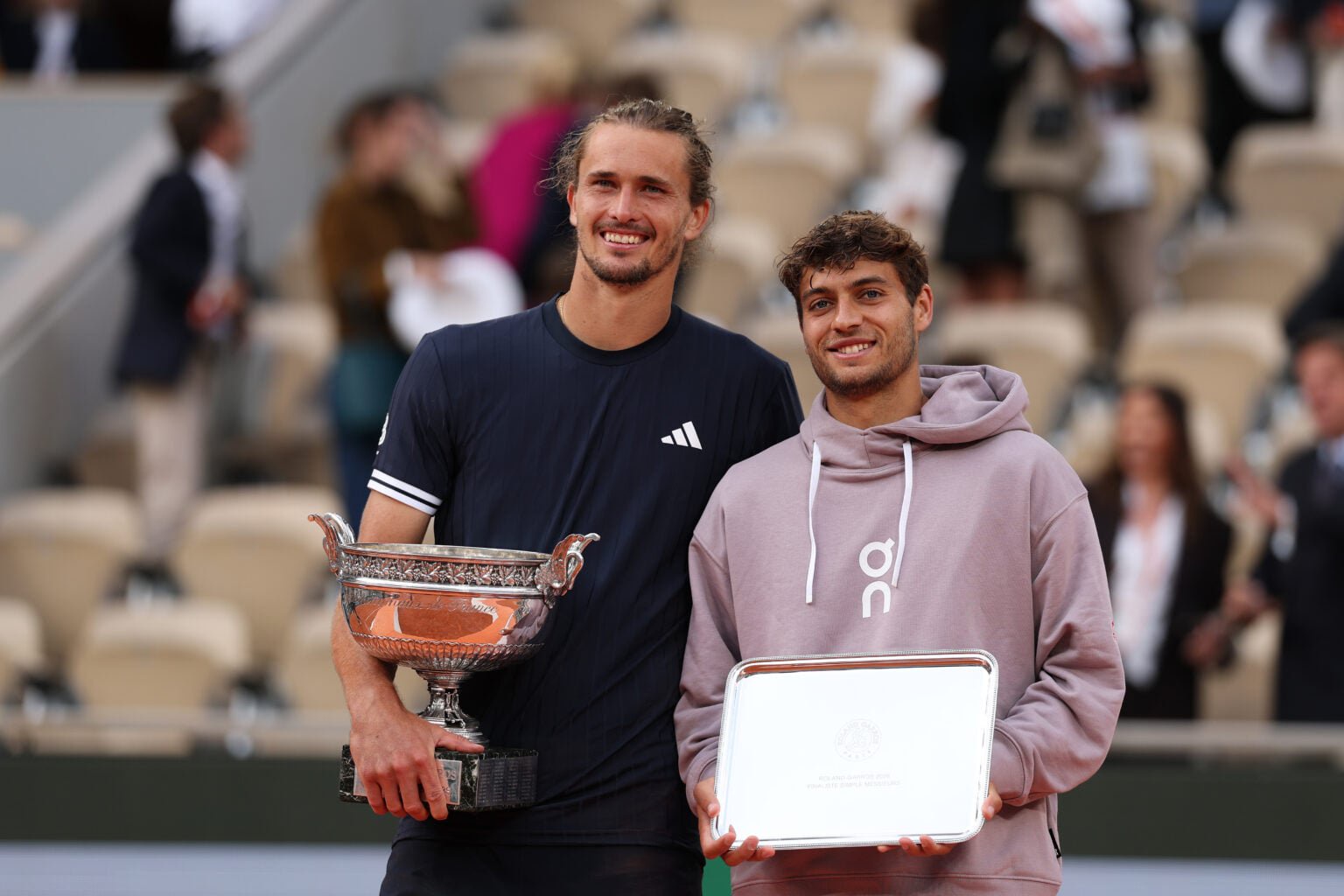 Alexander Zverev and Flavio Cobolli pose with their trophies after the 2026 French Open final.