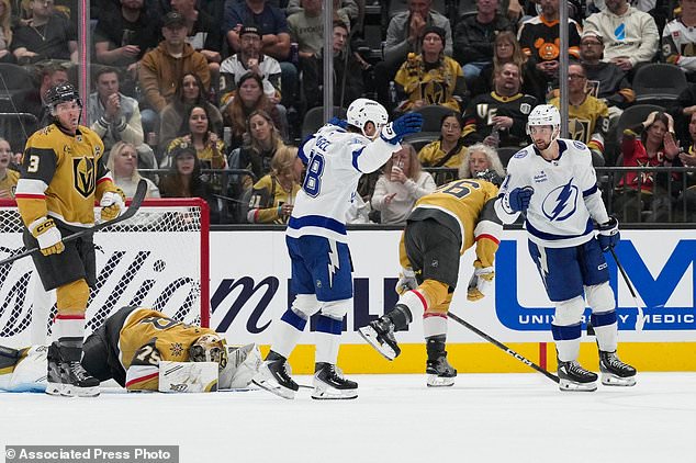 Tampa Bay Lightning center Anthony Cirelli, right, celebrates after scoring against the Vegas Golden Knights during the second period of an NHL hockey game Tuesday, Oct. 20, 2026, in Las Vegas. (AP Photo/John Locher)