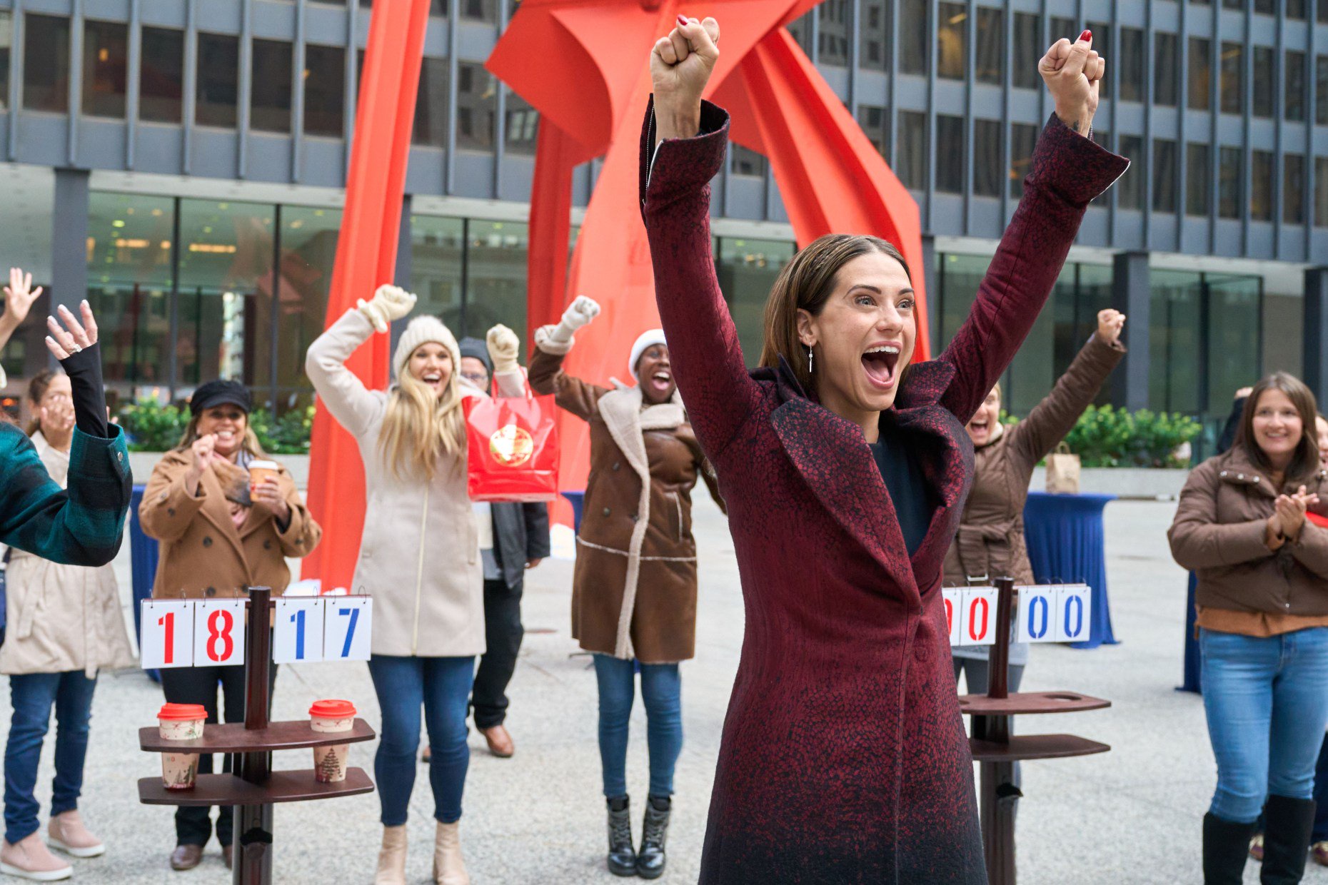 Avery (Lyndsy Fonseca) celebrates after winning a cornhole tournament in downtown Chicago in "Holiday Touchdown: A Bears Love Story." (Elizabeth Sisson/Hallmark Media)