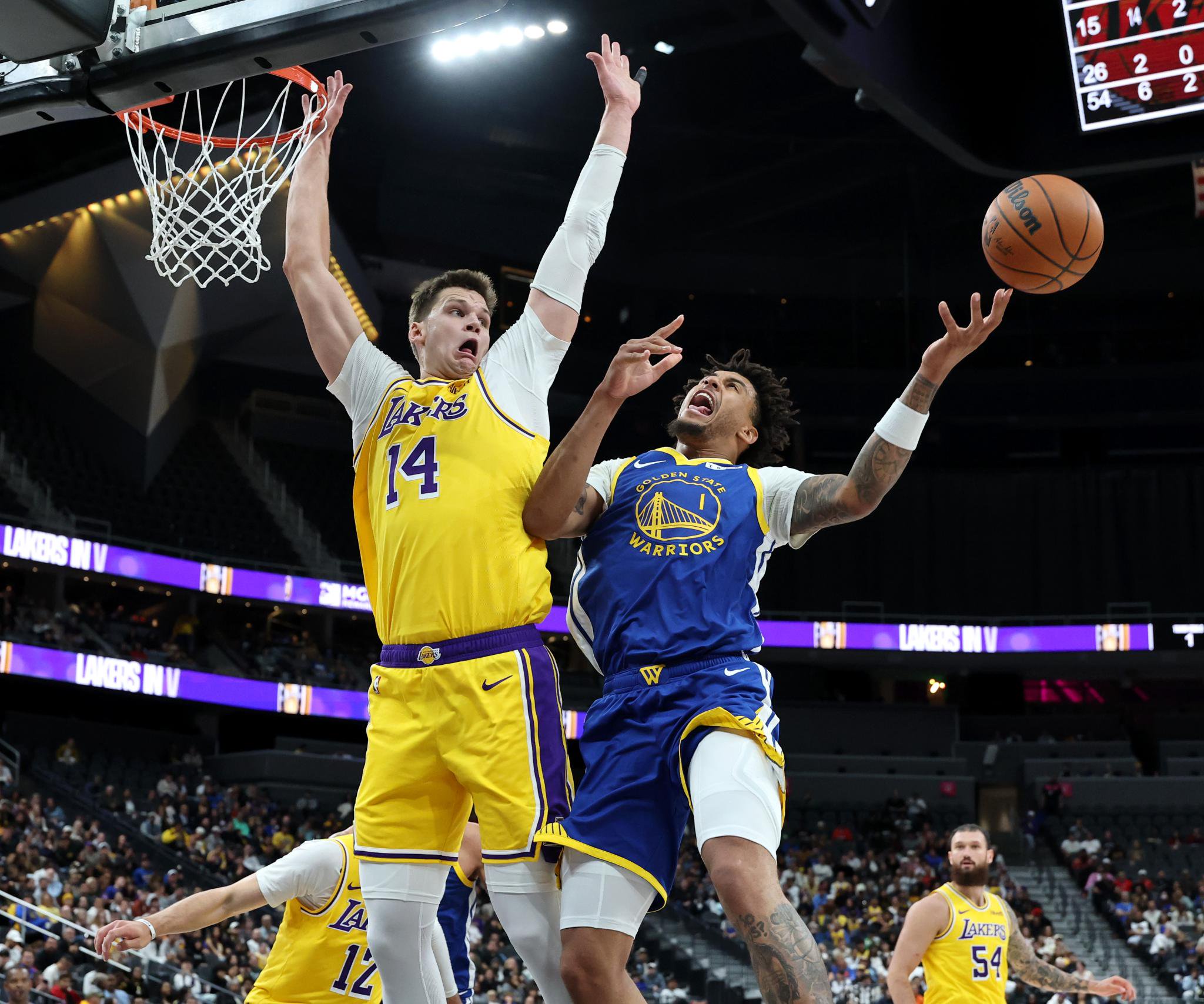 Yaxel Lendeborg of the Golden State Warriors is fouled by Walker Kessler of the Los Angeles Lakers during a preseason game.