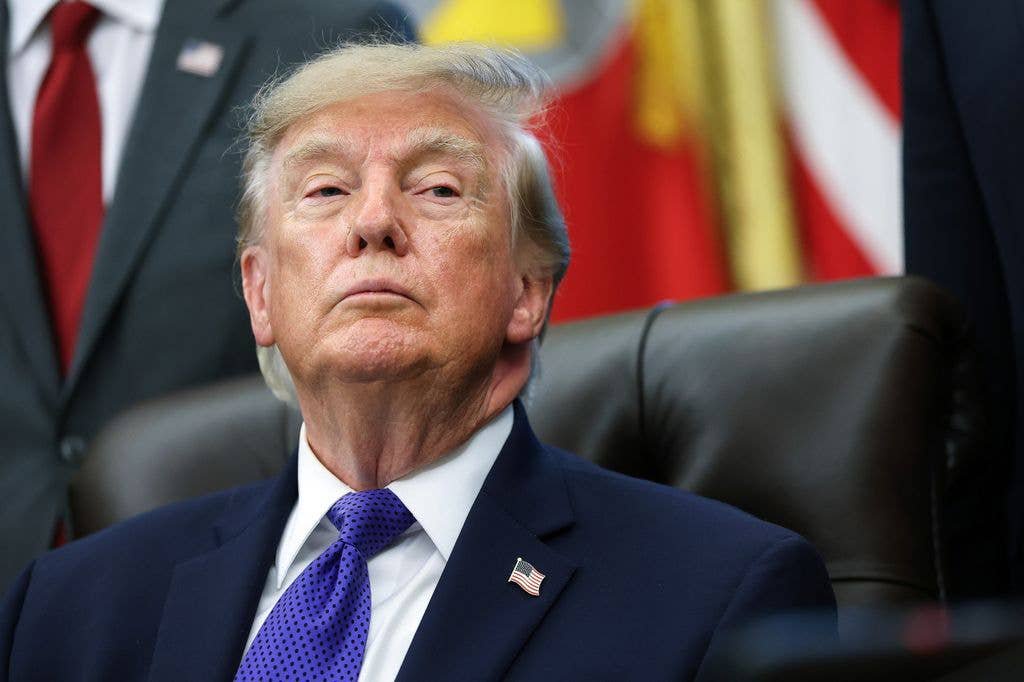Donald Trump listens to a reporters question in the Oval Office 