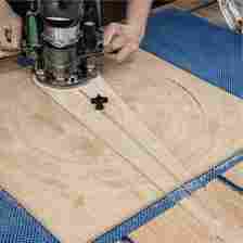 Router utilizing a circle cutting jig to cut large circles into wood.