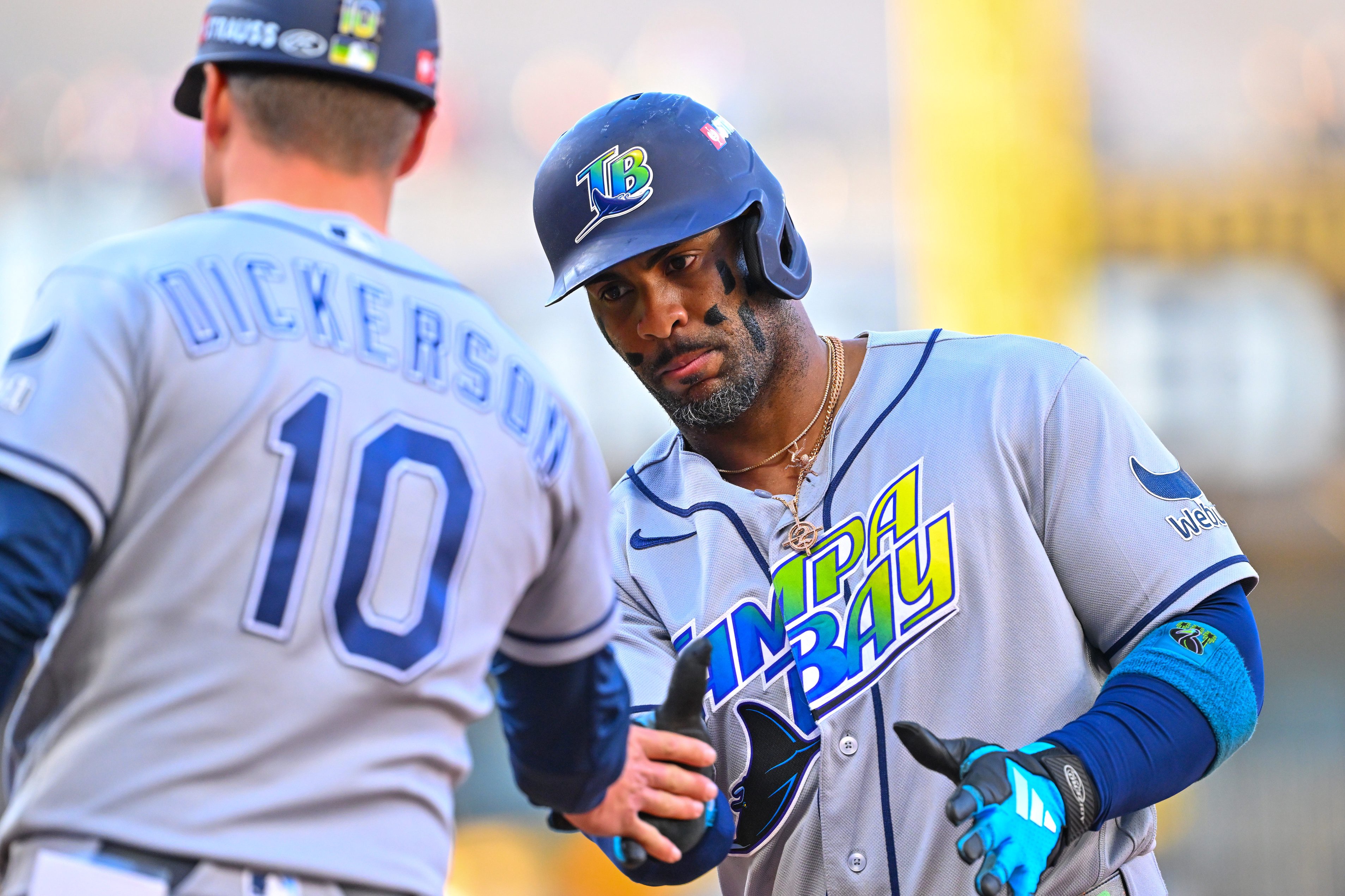 Yandy Díaz (right) of the Tampa Bay Rays celebrates with Corey Dickerson (10) after hitting a single against the Cleveland Guardians in Game 5 of the ALCS at Progressive Field on Oct. 18, 2026.