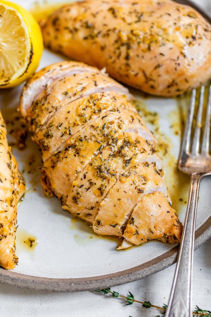 Chicken breasts on a plate with a lemon soy marinade