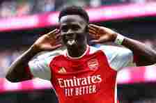 Bukayo Saka cups his ears in celebration after scoring for Arsenal against Tottenham