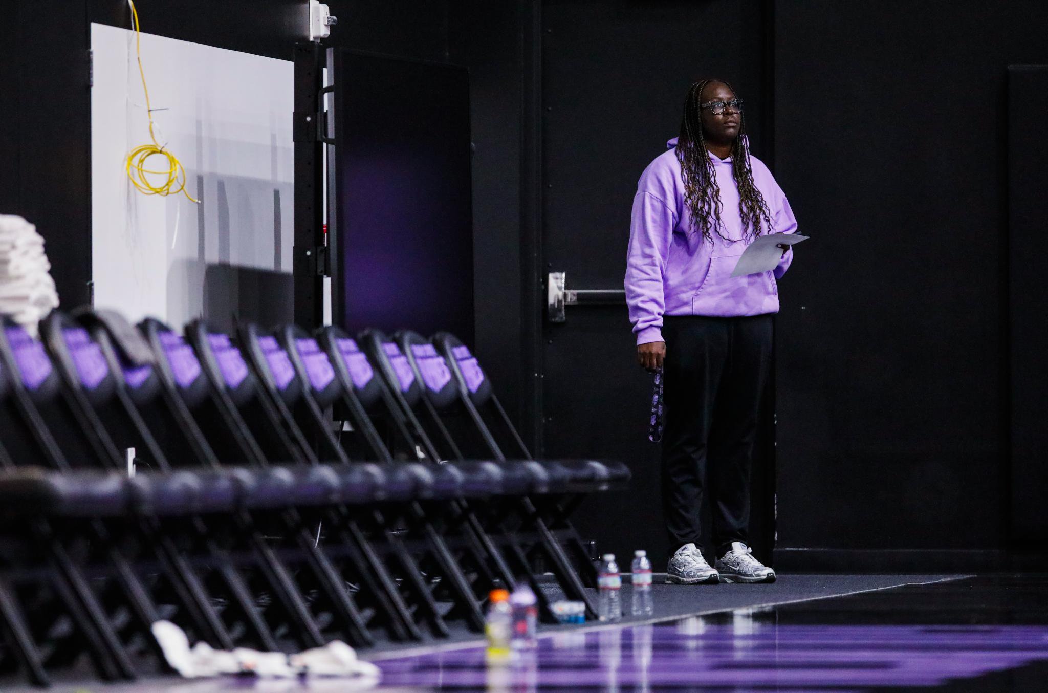 Golden State Valkyries general manager Ohemaa Nyanin watches practice, holding a paper in her hand.