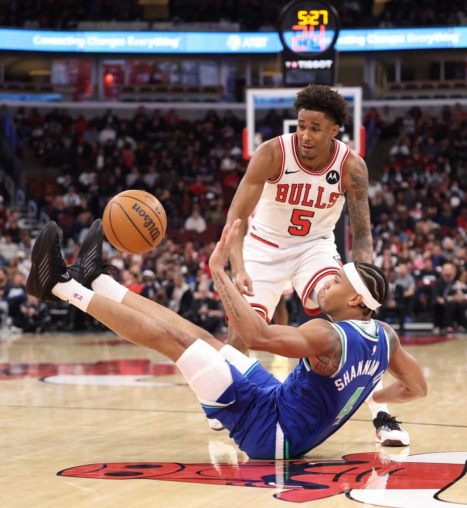 Timberwolves guard Terrence Shannon Jr. falls to the floor on a loose ball chase with Bulls guard Dailyn Swain (5) in the second quarter of a preseason game at the United Center on Oct. 16, 2026, in Chicago. (John J. Kim/Chicago Tribune)
