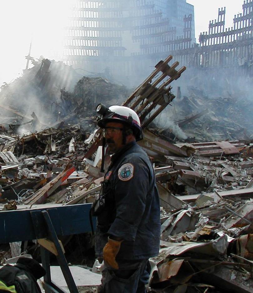 Dennis LeVasseur stands amidst the debris at Ground Zero in the World Trade Center site.