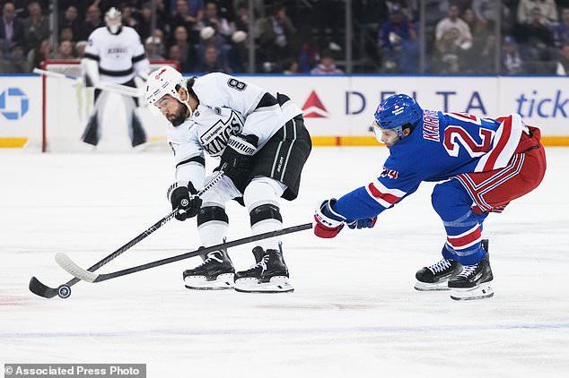New York Rangers' Tye Kartye (24) defends Los Angeles Kings' Drew Doughty (8) during the first period of an NHL hockey game Monday, Oct. 26, 2026, in New York. (AP Photo/Frank Franklin II)