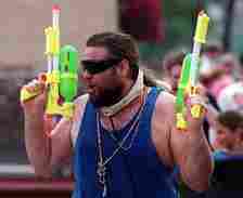 A.J. Drew, of the short north, kept himself prepared for action with two large water guns during the unofficial Doo-Dah parade on July 4, 1994.