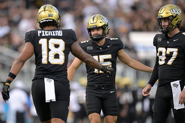 Central Florida kicker Will Stone (15) is congratulated by Caden Piening (18) and Mason Denaburg (97) after kicking a 19-yard field goal during the first half of an NCAA college football game against BYU, Saturday, Oct. 24, 2026, in Orlando, Fla. (AP Photo/Phelan M. Ebenhack)