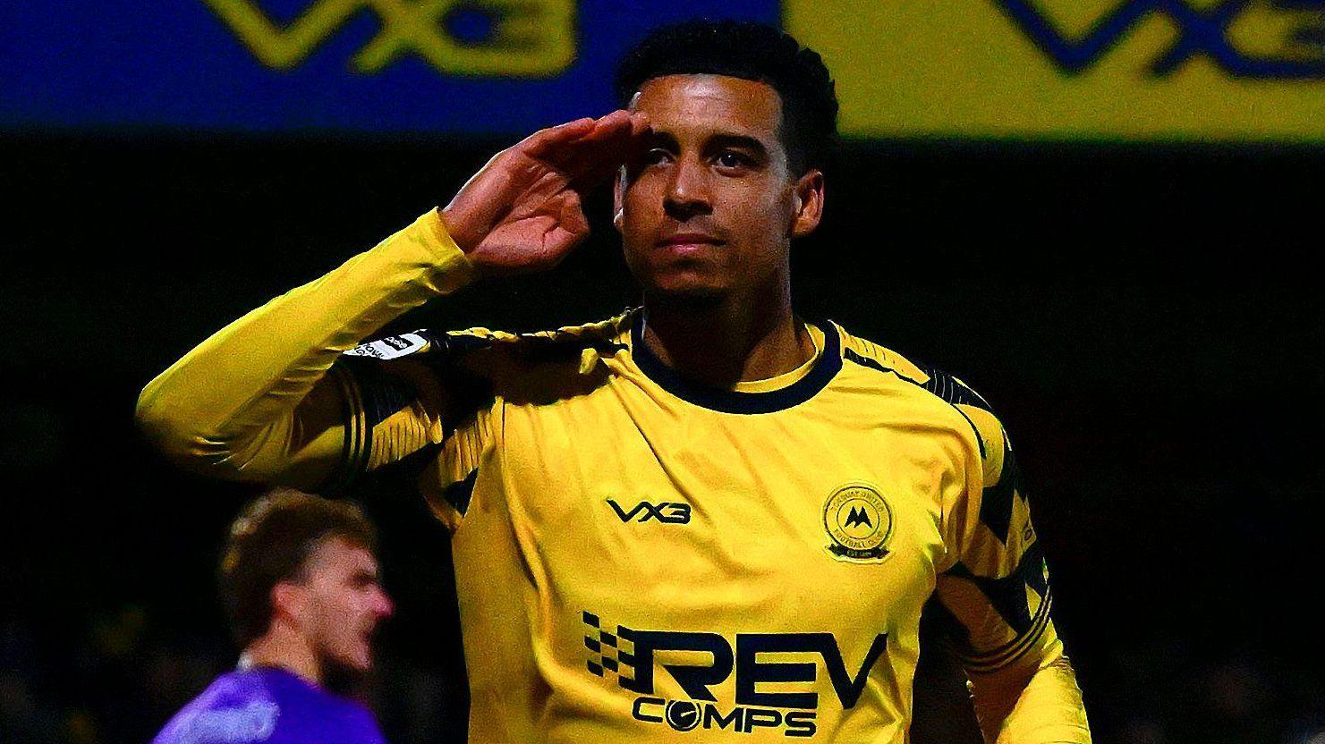 Louis Dennis salutes after scoring a goal for Torquay