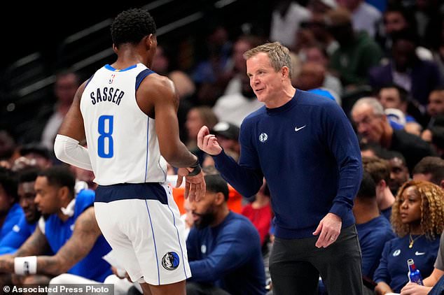 Dallas Mavericks head coach Dusty May talks with guard Marcus Sasser during the first half of an NBA basketball game against the Oklahoma City Thunder Wednesday, Oct. 28, 2026, in Dallas. (AP Photo/Jeffrey McWhorter)