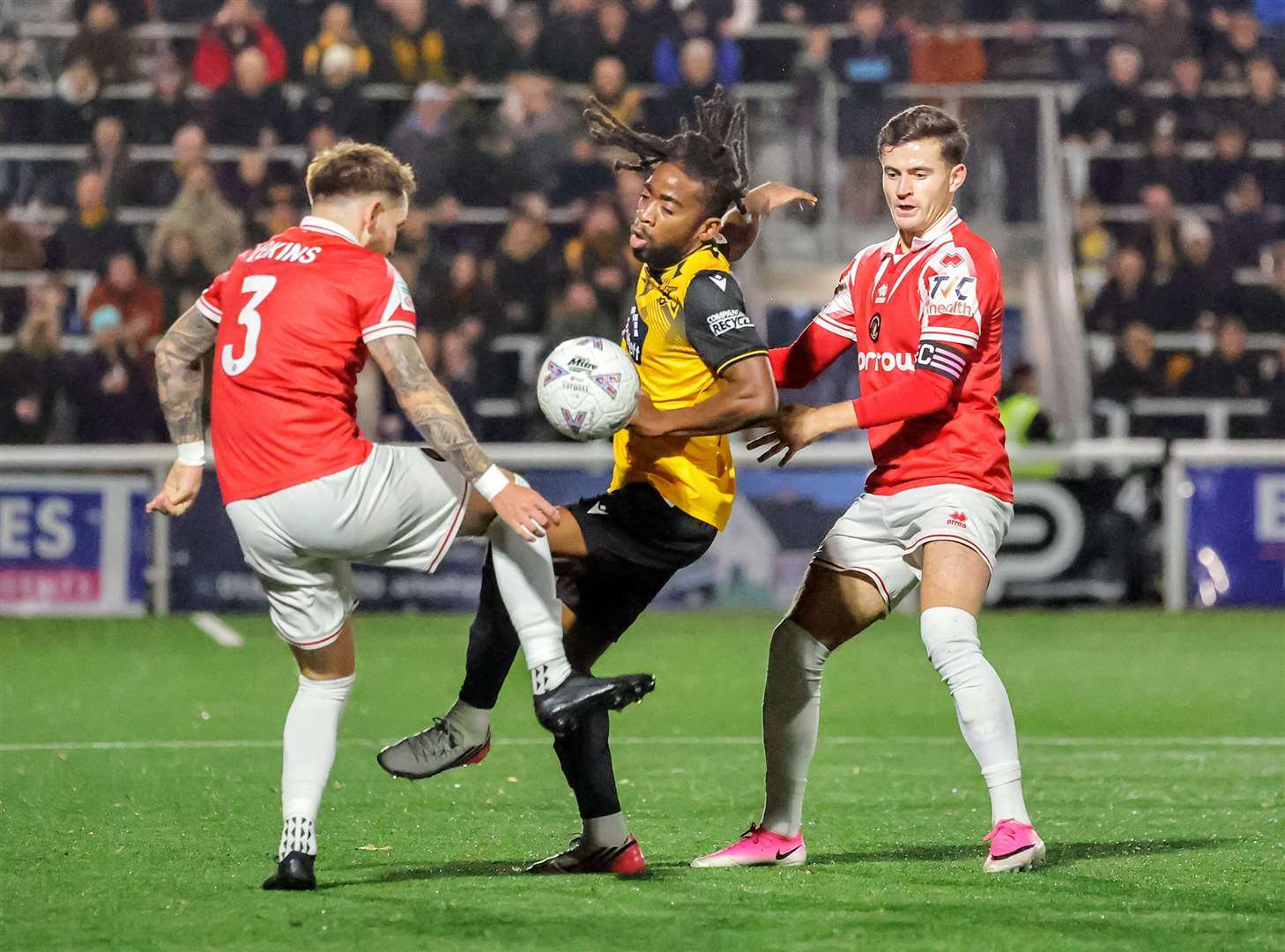 Maidstone winger Leone Gravata finds himself between Jake Vokins and James Vennings. Picture: Helen Cooper
