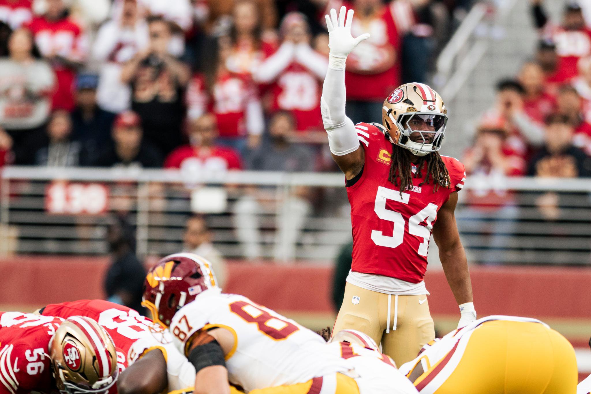 San Francisco 49ers linebacker Fred Warner (54) gestures during a game against the Washington Commanders.