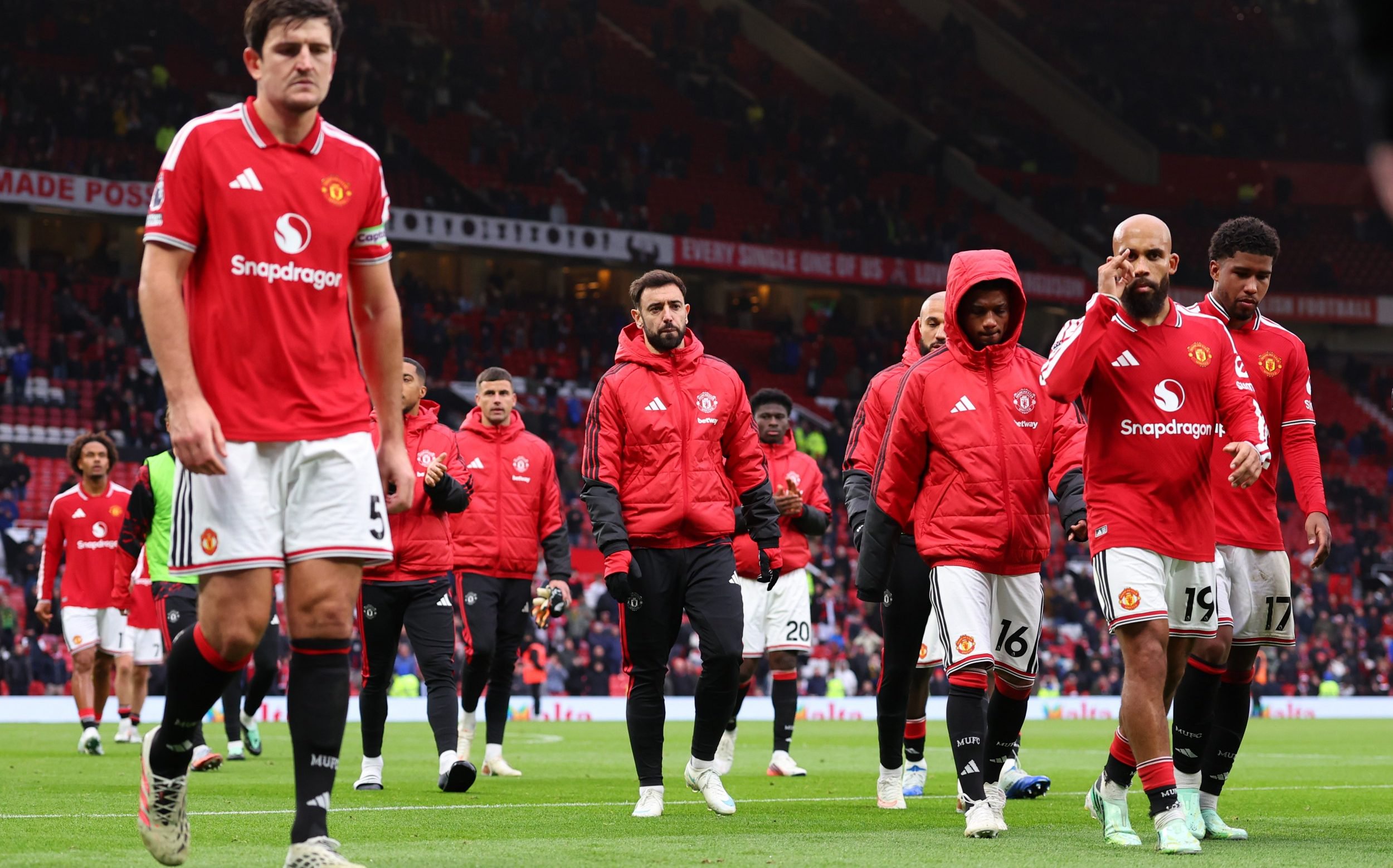 Manchester United players trudge off after losing 3-0 at home to Bournemouth