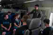 Senior Airman Christian Conde, 960th Airborne Air Control Squadron mission systems operator explains his duties to Premiere College Intern Program members, June 26, at Tinker Air Force Base, Oklahoma.