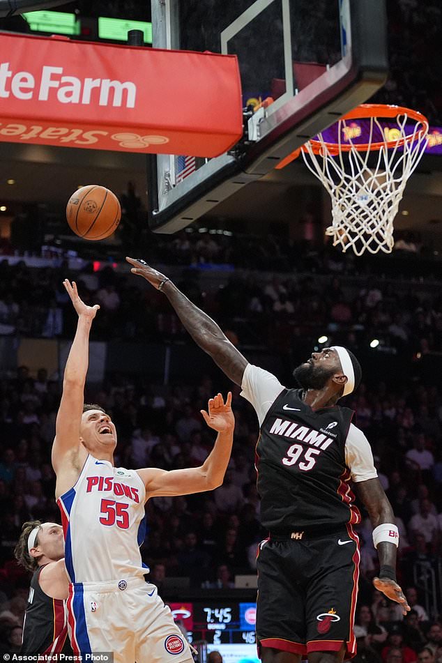 Detroit Pistons forward Duncan Robinson (55) is defended by Miami Heat forward Bobby Portis Jr. (95) during the first half of an NBA basketball game, Friday, Oct. 23, 2026, in Miami. (AP Photo/Rebecca Blackwell)