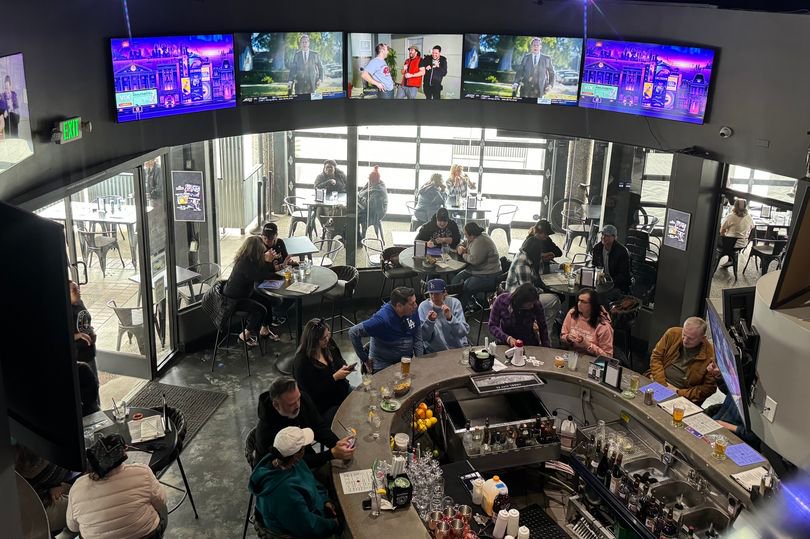 The interior of Watch Me! Sports Bar features a plethora of TV screens, each displaying a different women's sport