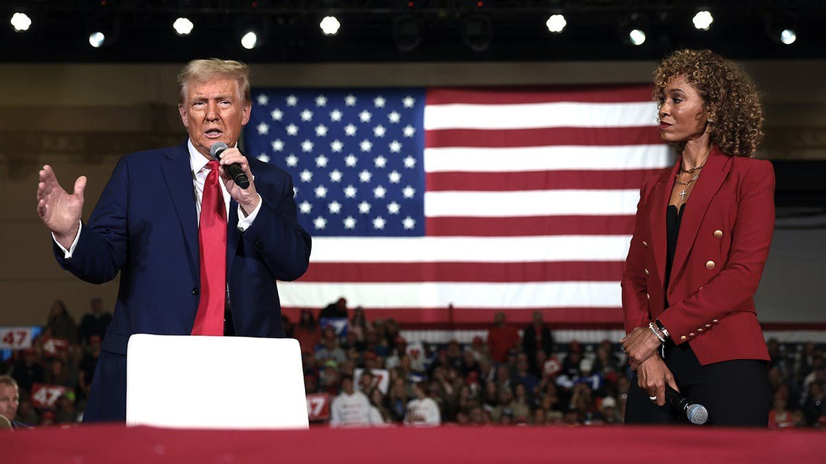 Donald Trump speaks alongside moderator Sage Steele at a town hall campaign event.