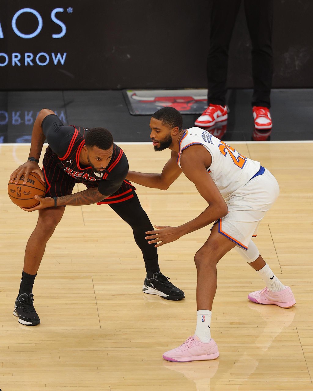 Mikal Bridges of the New York Knicks plays defense on Norman Powell of the Chicago Bulls during an NBA game.