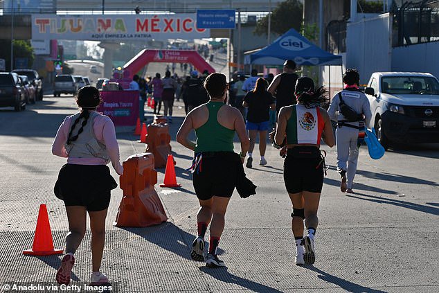 Dozens of runners who competed in a grueling half marathon from California to Mexico returned to the United States to find that their cars had gone missing