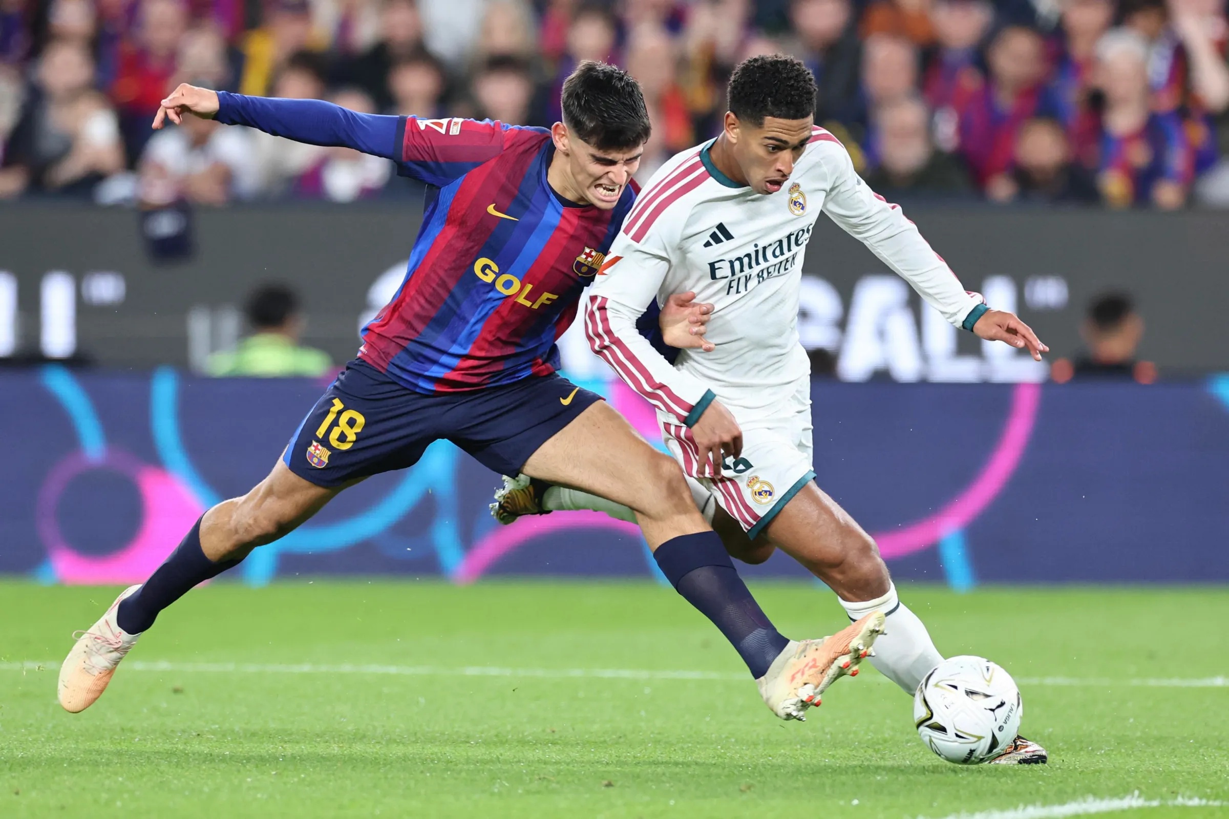 Real Madrid’s English midfielder #05 Jude Bellingham (R) vies with Barcelona’s Spanish defender #18 Gerard Martin during the Spanish league football match between FC Barcelona and Real Madrid CF at Camp Nou Stadium in Barcelona on October 25, 2026. (Photo by Josep LAGO / AFP via Getty Images)
