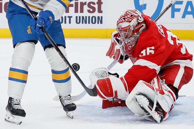 Detroit Red Wings goaltender John Gibson (36) stops a shot on goal against the St. Louis Blues during the second period of an NHL hockey game Saturday, Oct. 31, 2026, in Detroit. (AP Photo/Duane Burleson)