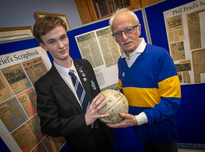Tony O'Doherty pictured with his grandson Aaron, then head boy of St Columb's College, holding the ball used in the Hogan Cup final in 1966 Picture: Jim McCafferty Photography