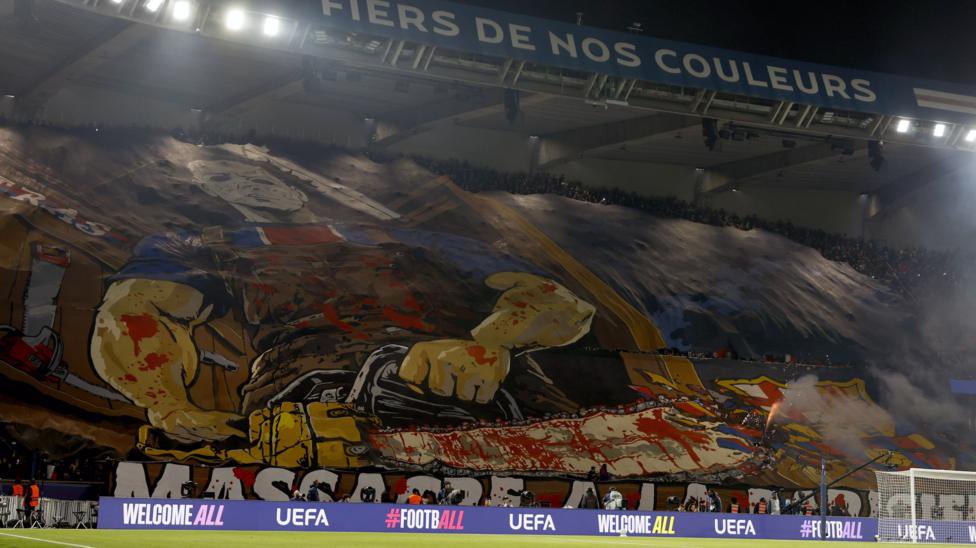 A colourful banner featuring a man holding a bloody chainsaw