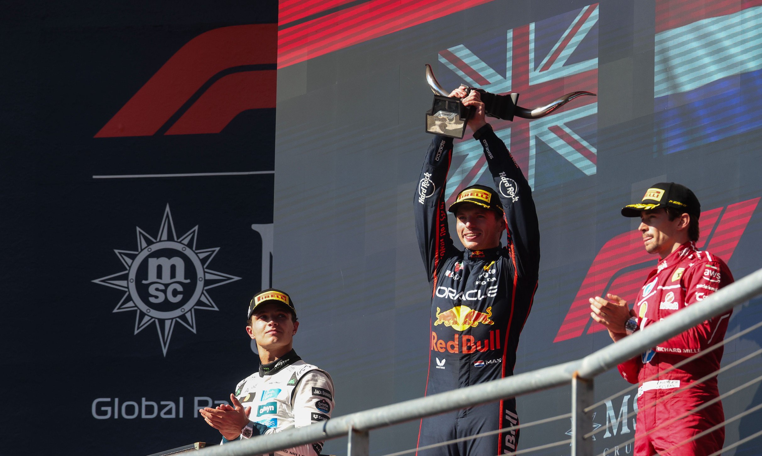 Oct 19, 2025; Austin, TX, USA; Oracle Red Bull Racing driver Max Verstappen (1) of Team Netherlands, winner celebrates with McLaren Renault Team driver Lando Norris (4) of Team Great Britain, second place and Scuderia Ferrari HP driver Charles Leclerc (16) of Team Monaco ,third place at Circuit of The Americas Austin. Mandatory Credit: Thomas Shea-Imagn Images