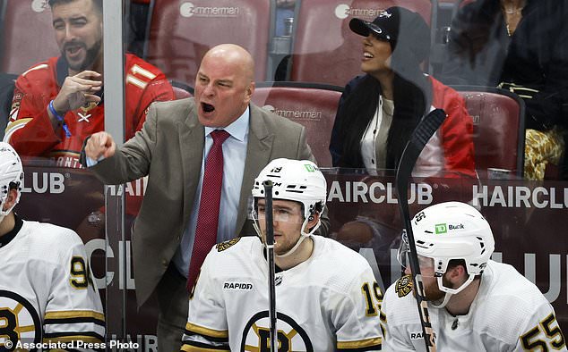 Boston Bruins head coach Jim Montgomery argues a call against the Florida Panthers during the third period of an NHL hockey game, Tuesday, March 26, 2024, in Sunrise, Fla. (AP Photo/Rhona Wise)