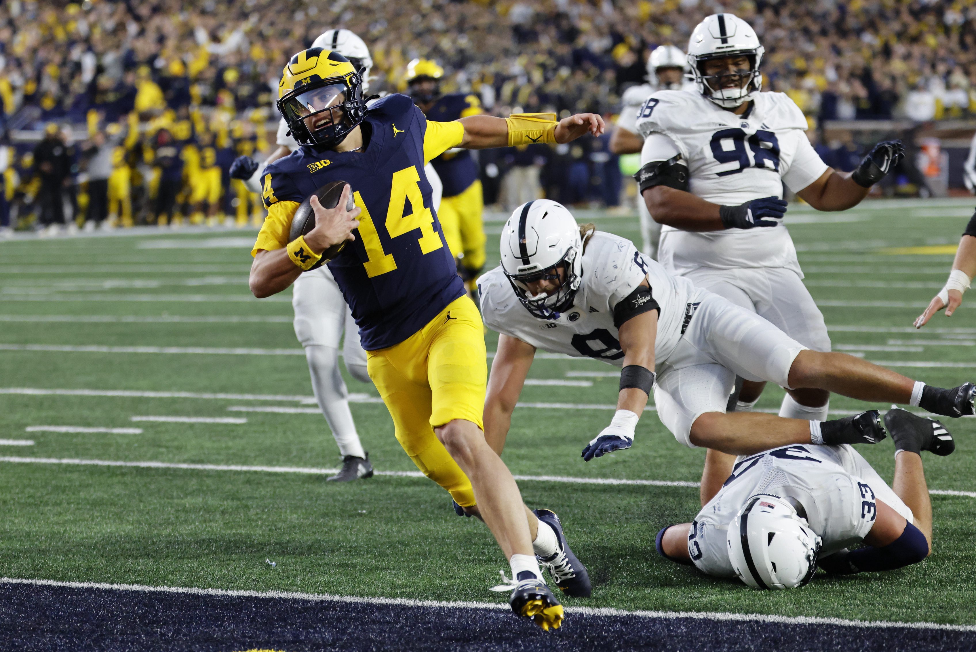 Oct 17, 2026; Ann Arbor, Michigan, USA;  Michigan Wolverines quarterback Tommy Carr (14) runs the ball in for a touch down in  the second half against the Penn State Nittany Lions at Michigan Stadium.  Mandatory Credit: Rick Osentoski-Imagn Images